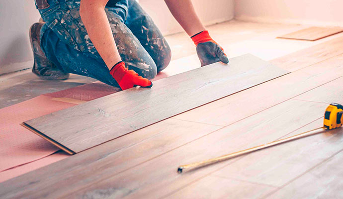 worker repairing wooden floor