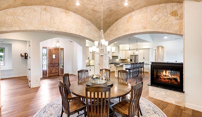 A view from a formal dining room looking into a modern kitchen