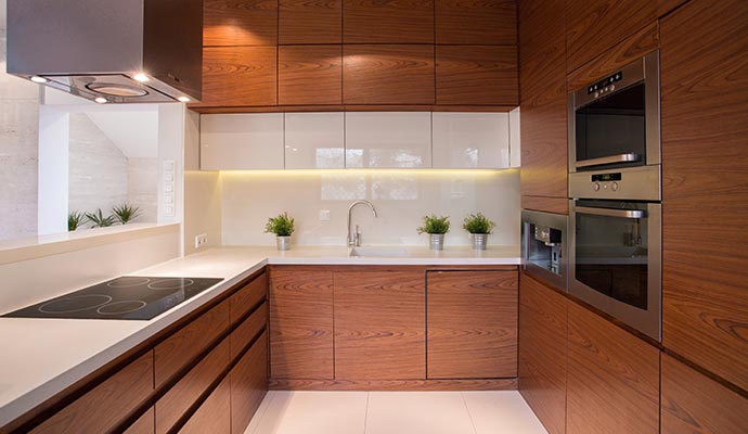 A sleek, contemporary kitchen featuring rich horizontal-grain wood cabinetry