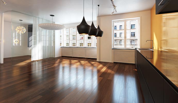 A modern interior with polished hardwood floors, representing professional assessment to determine the most effective flooring service.