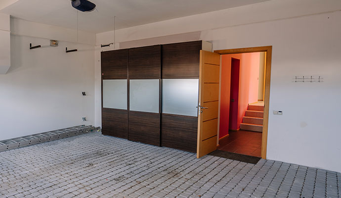 A clean garage with a modern wardrobe for storage.