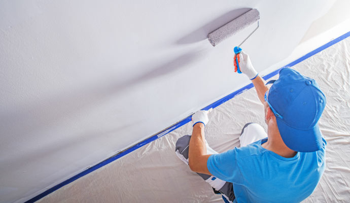 A professional painter painting the interior of a commercial building