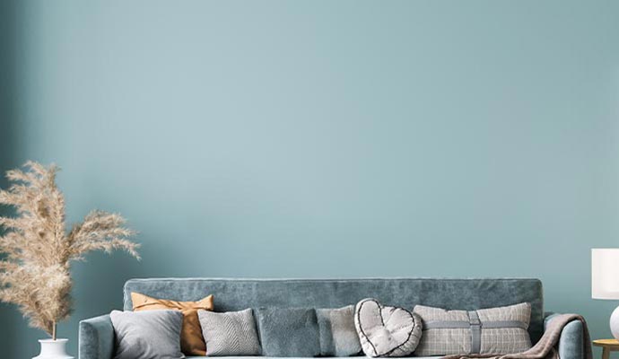 Living room wall with semi-gloss finish Interior wall painted with semi-gloss paint behind a sofa in a living room.