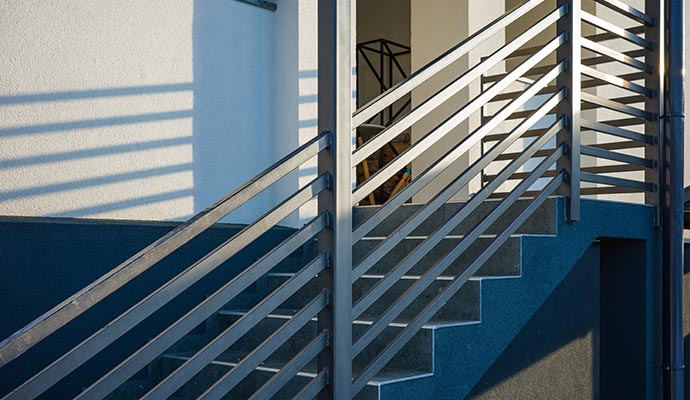 Modern outdoor staircase with sleek metal railings and handrails
