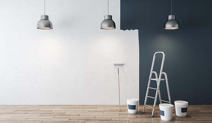 A wall partially painted with dark blue and white colors