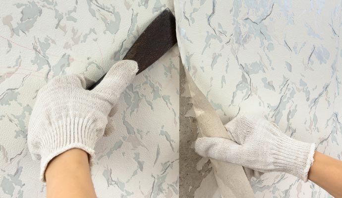 A two-panel image showing a worker's gloved hands removing old wallpaper, first by lifting an edge with a scraper, then by peeling it off the wall.