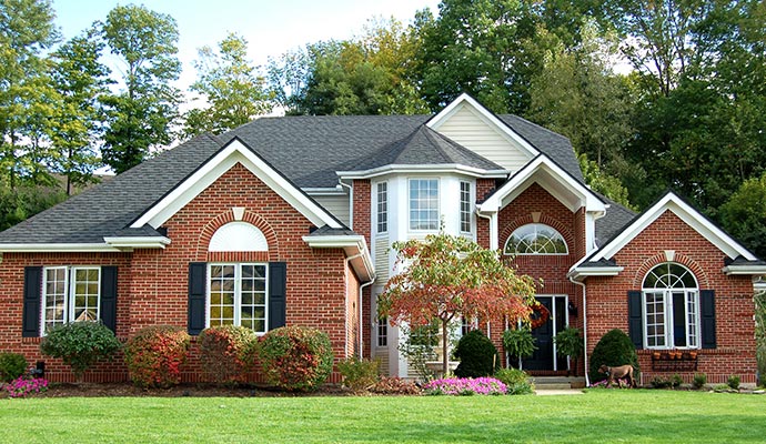Residential home with classic red brick exterior walls and white trim
