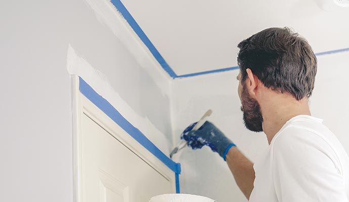 worker is painting on the family room