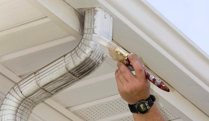 worker painting gutter