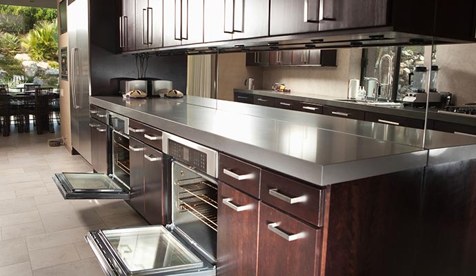 A modern kitchen featuring dark wood cabinets A modern kitchen featuring dark wood cabinets