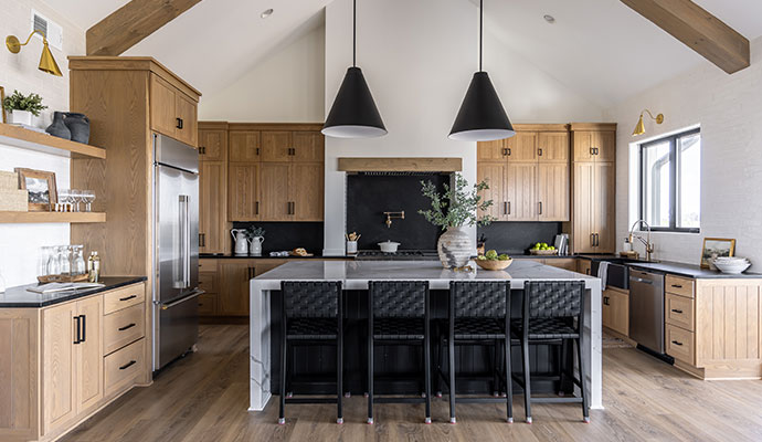 A modern kitchen with natural wood cabinets and a large island.