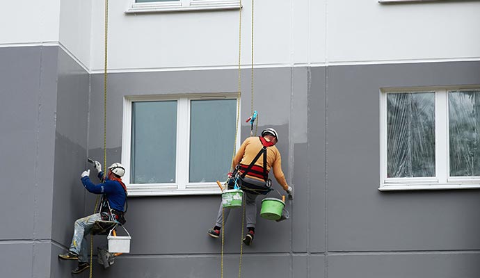 A professional team painting exterior wall A professional team painting exterior wall