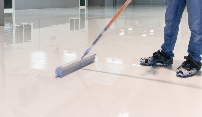 worker cleaning garage floor